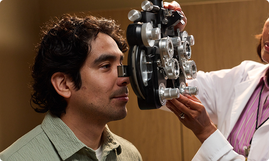 Man receiving an eye exam from optometrist.