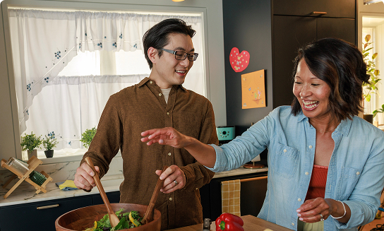 Happy couple preparing a healthy meal together.