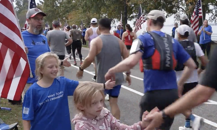 Children high-fiving runners