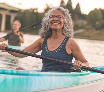 Smiling woman kayaking